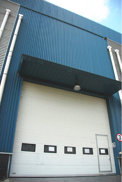 Apresure las puertas seccionales industriales de la seguridad exterior 1.0m/s que ruedan el modelo trasero